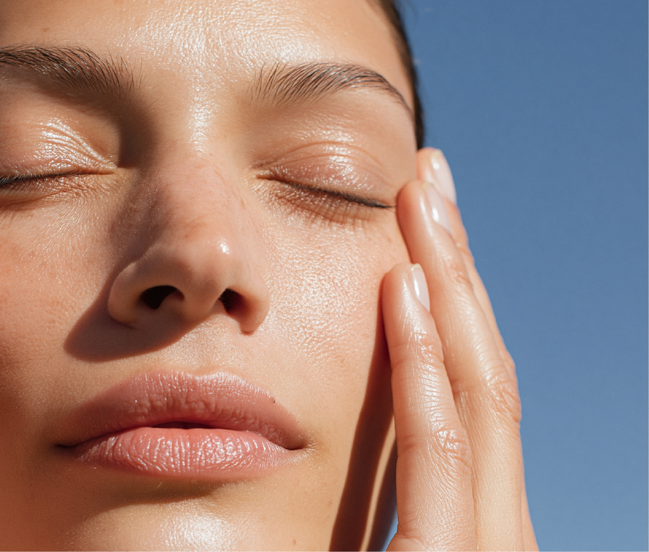 Serene face close up gentle touch under eye skincare routine natural skin glow relaxed expression